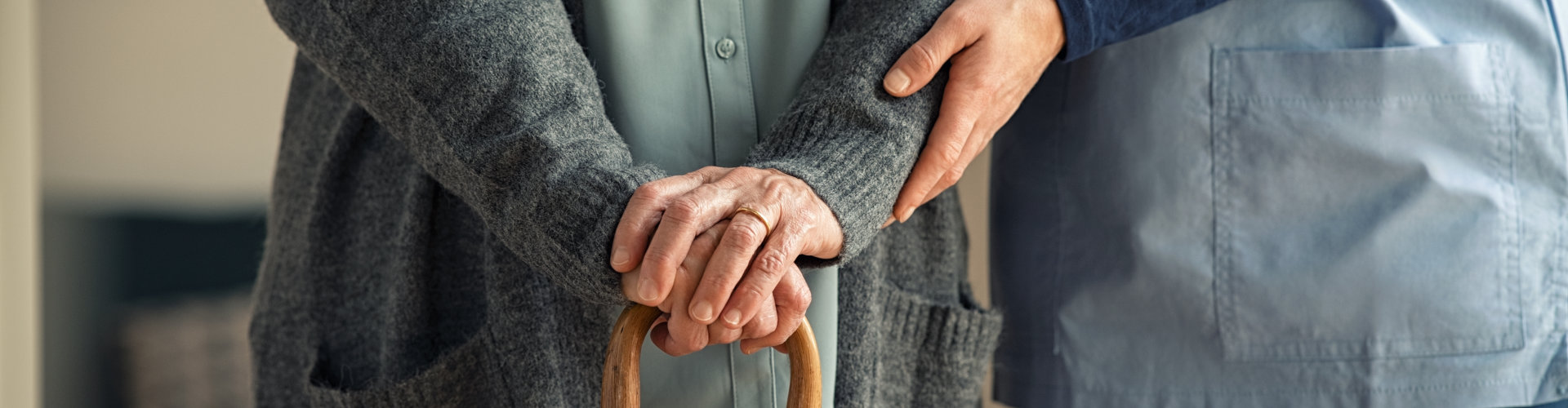 caregiver doctor helping an elderly woman at clinic